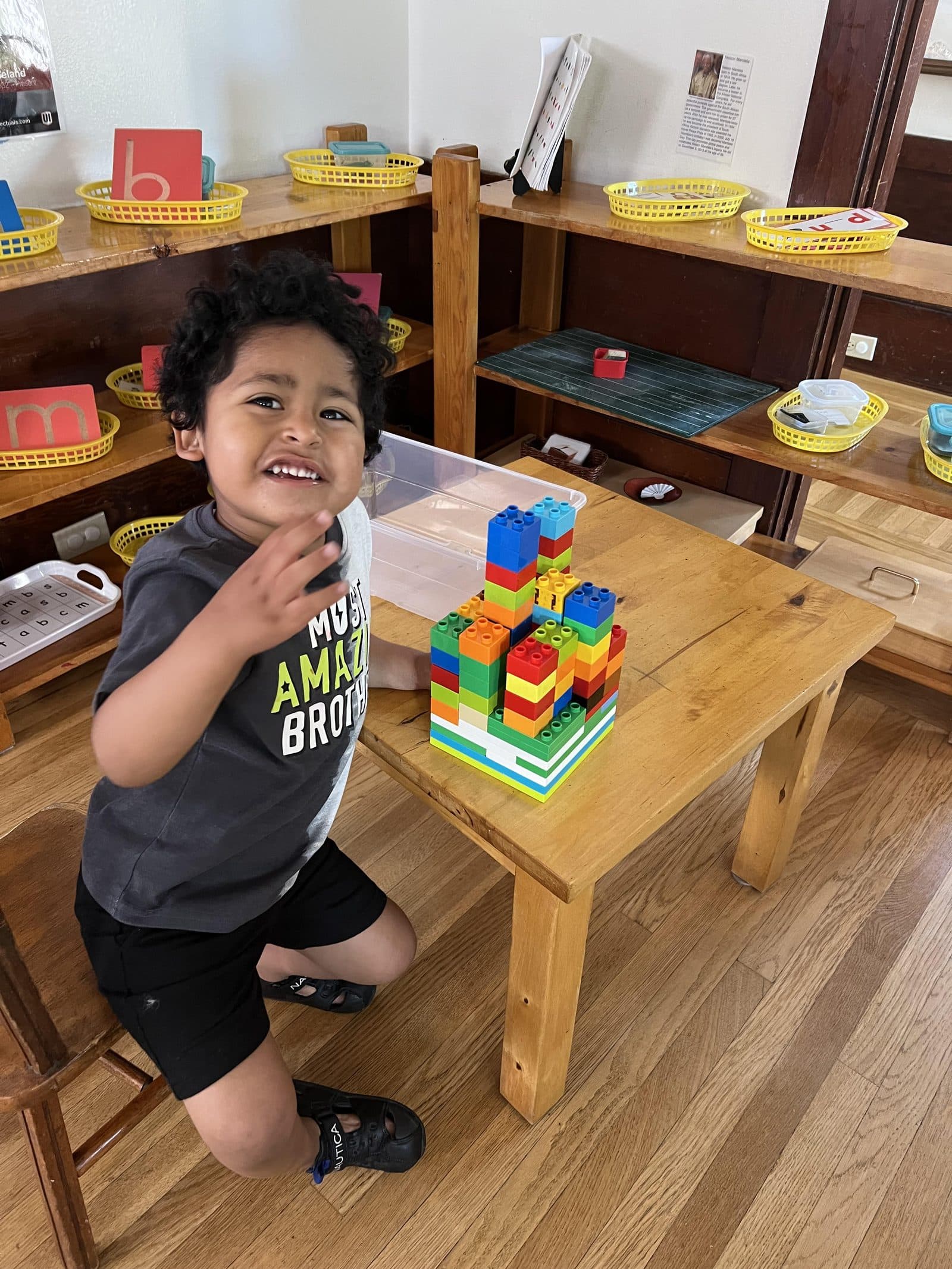 Student building a tower with stacking blocks at Pacific Campus