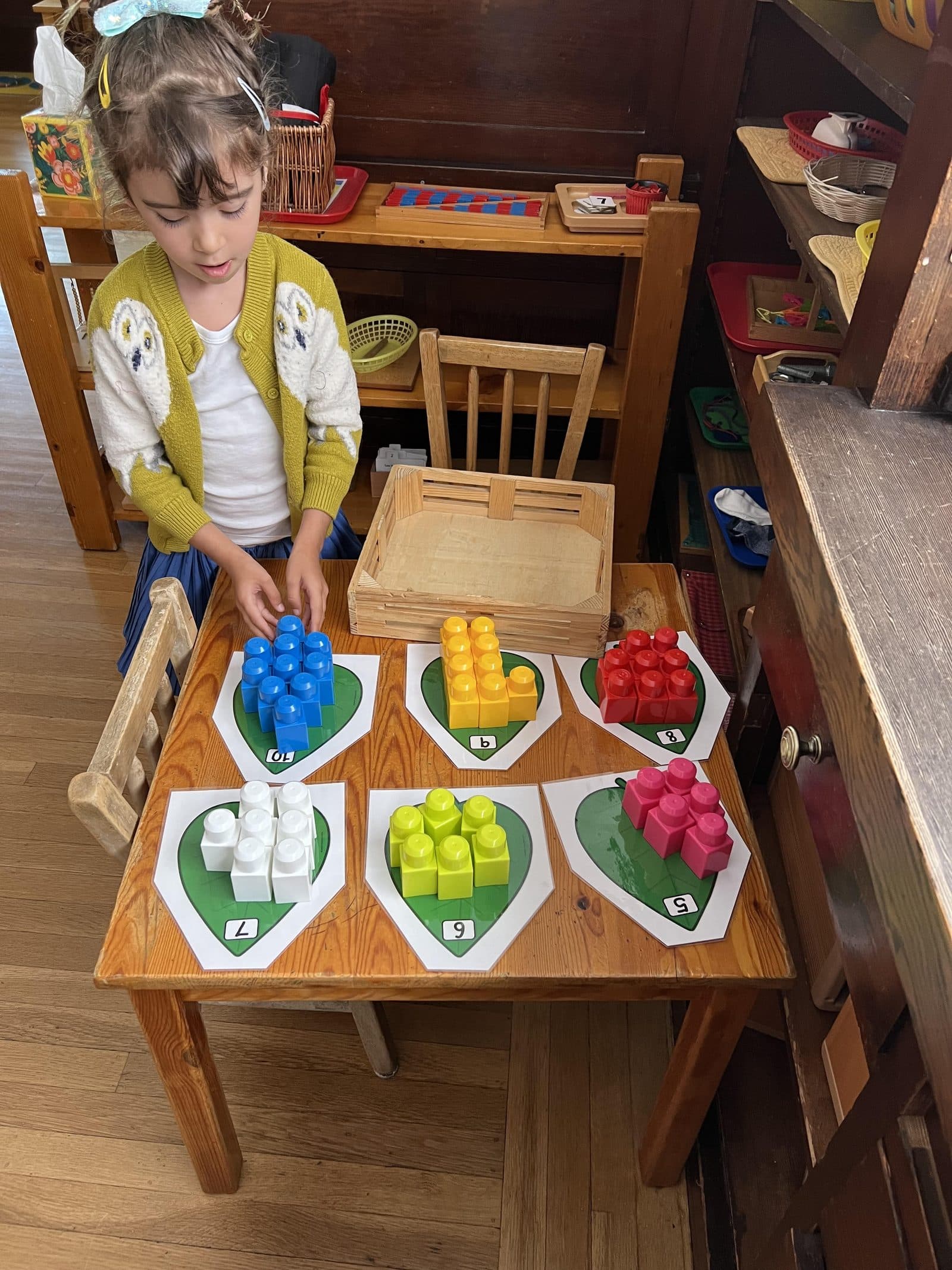Student working on a counting and quantity Montessori material